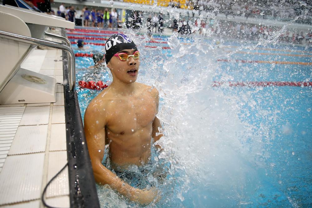 Evan at the pool wall after a race